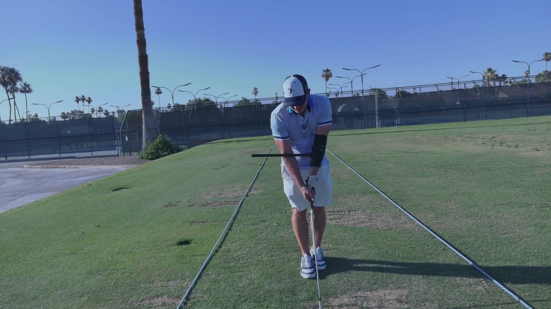 Video showing golfer trying out the form coach training aid